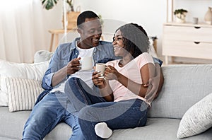 Young black man and woman enjoying weekend at home together