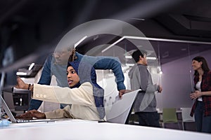 Young black muslim female software developer at work