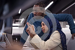 Young black muslim female software developer at work
