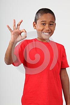 Young black school boy 9 gives happy okay sign