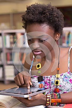 Young Black student using her tablet, studying