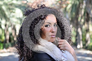 Young black woman, afro hairstyle, in urban background