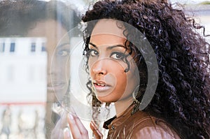 Young black woman, afro hairstyle, in urban background