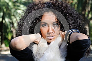 Young black woman, afro hairstyle, in urban background