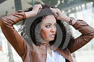 Young black woman, afro hairstyle, in urban background