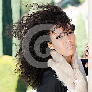 Young black woman, afro hairstyle, in urban background