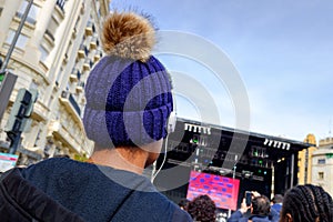 Young black woman enjoying listening to a live concert with headphones on her back