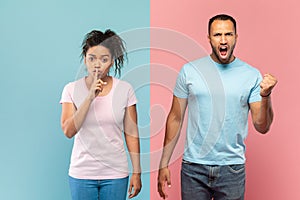 Young black woman gesturing hush sign, holding finger near mouth, man screaming and clenching fist at camera