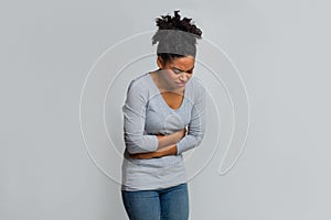 Young black woman having menstrual abdominal pain photo