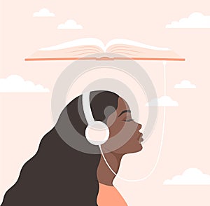 Young black woman in headphones with closed eyes listening to an audiobook