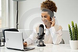 Young black woman is making an online podcast recording for her online show. An attractive African-American business