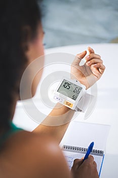 Young Black Woman Measuring Blood Pressure At Home