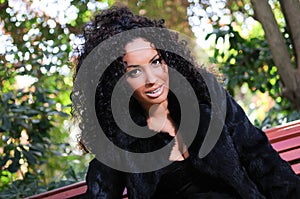 Young black woman, model of fashion in a garden