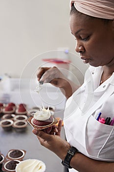 Young black woman preparing food in a bakery, close up