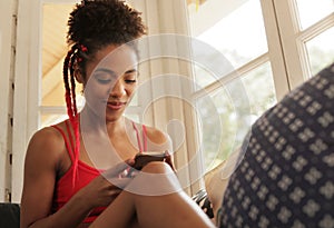 Young Black Woman Reading Phone Message And Smiling