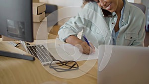 Young Black woman sitting at desk and working on computer