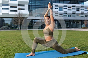 Young black woman in sportswear practicing yoga, doing stretching exercises at park, copy space