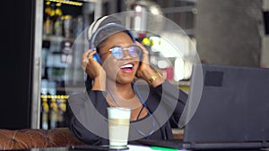 A young black woman using a laptop for studying, watching online lectures, workshops and master classes. Video chat job