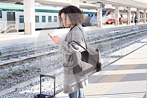 Young black woman waiting for the train