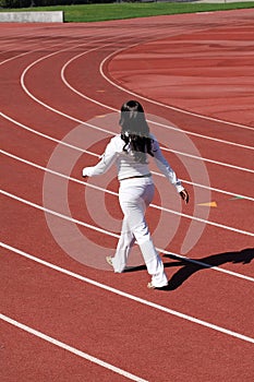 Young black woman walking sweat suit on track