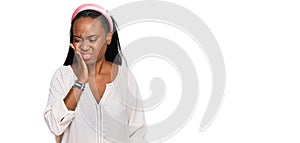Young black woman wearing casual clothes touching mouth with hand with painful expression because of toothache or dental illness