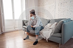 Young black woman wearing protective mask against COVID virus suffering from depression