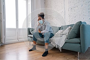 Young black woman wearing protective mask against COVID virus suffering from depression