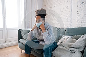 Young black woman wearing protective mask against COVID virus suffering from depression