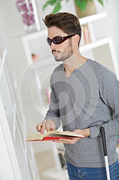 Young blind reading book
