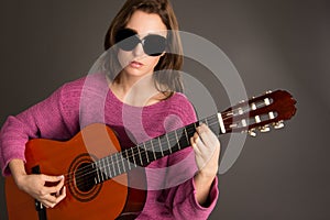 Young blind woman playing guitar