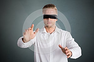 Young Blindfolded Businessman