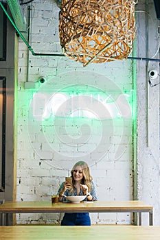 Young blogger woman working on social media in a cafeteria