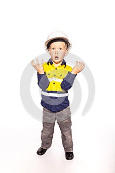Young blond caucasian boy hands outstretched role playing as a frustrated construction worker supervisor