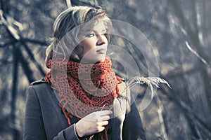 Young blond fashion woman walking in autumn forest