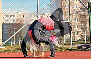 Young blond girl dancing break dance