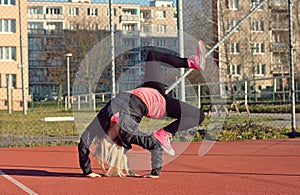 Young blond girl dancing break dance