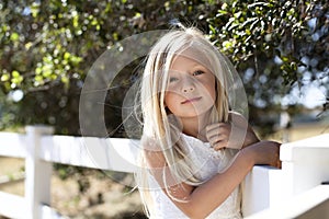 Young Blond Girl on Fence