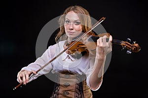Young blond girl playing the violin