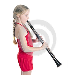 Young blond girl in red playing clarinet