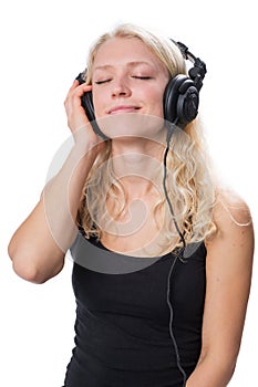 Young blond girl wearing headphones and enjoying music