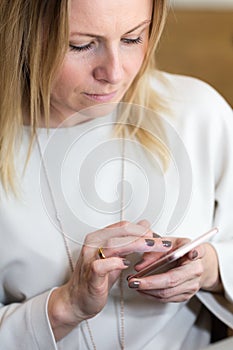 Young blond hair business woman writing a text message using mes