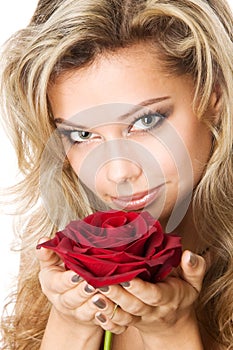 Young blond holding a red rose