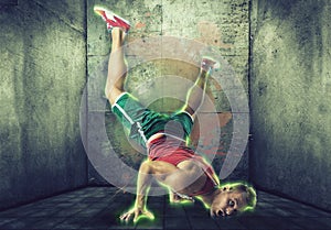 Young blond man in neon effect dancing breakdance photo