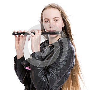Young blond teen girl and piccolo flute in studio against white background