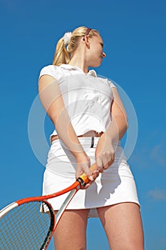 Young blond tennis-player in white sportwear outd