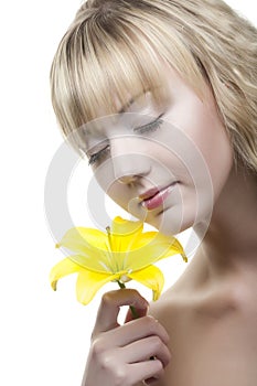 Young blond with white lily flowers