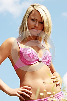 Young blond woman in bikini outdoors