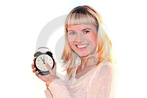 Young blond woman with clock