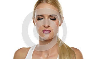 Young blond woman closed eyes and makeup