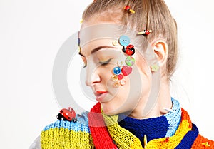 Young blond woman with creativity hairstyle with colored buttons